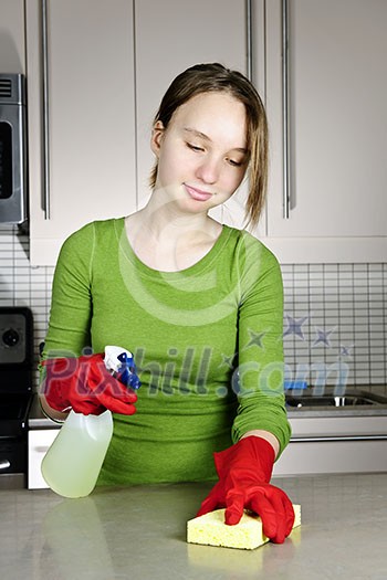 Girl cleaning kitchen with sponge and rubber gloves Girl cleaning kitchen with sponge and rubber gloves