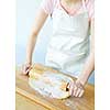 Spreading out cookie dough with wooden rolling pin