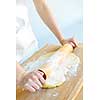 Spreading out cookie dough with wooden rolling pin