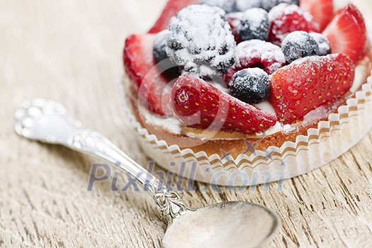 Fancy gourmet fresh fruit dessert tart with spoon Fancy gourmet fresh fruit dessert tart with spoon