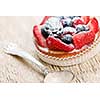 Fancy gourmet fresh fruit dessert tart with spoon
