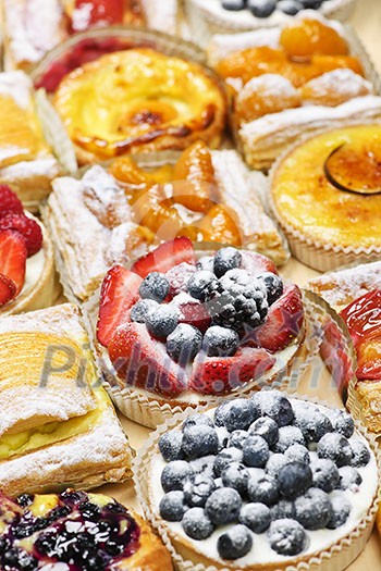 Background of assorted fresh sweet tarts and pastries Background of assorted fresh sweet tarts and pastries