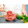 Chef cooking in kitchen with ground beef