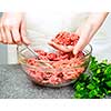 Chef cooking in kitchen with ground beef