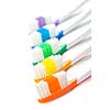Close up of multicolored toothbrushes on white background