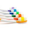 Close up of multicolored toothbrushes on white background