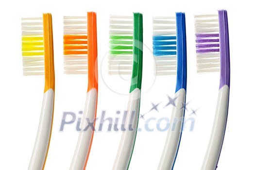 Close up of multicolored toothbrushes on white background Close up of multicolored toothbrushes on white background
