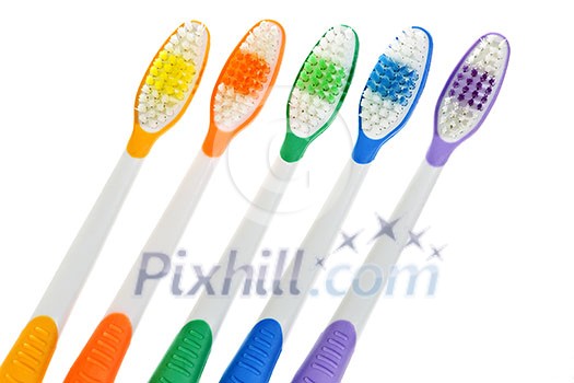 Close up of multicolored toothbrushes on white background Close up of multicolored toothbrushes on white background