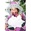 Portrait of happy teenage girl holding snow in gloves