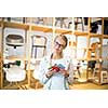 Pretty young woman  choosing the right material/color for her modern appartement interior (shallow DOF; color toned image)
