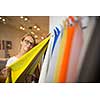 Pretty young woman  choosing the right material/color for her modern appartement interior (shallow DOF; color toned image)