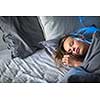 Beautiful young woman sleeping in bed (colour toned image; shallow DOF)