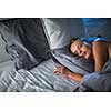 Beautiful young woman sleeping in bed (colour toned image; shallow DOF)