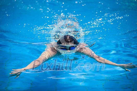 Young man swimming in a pool Young man swimming in a pool