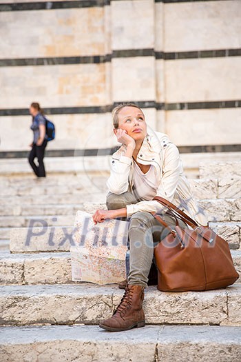 Gorgeous female tourist with a map discovering a foreign city (shallow DOF; color toned image) Gorgeous female tourist with a map discovering a foreign city (shallow DOF; color toned image)
