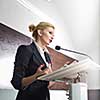 Pretty, young business woman giving a presentation in a conference/meeting setting (shallow DOF; color toned image)