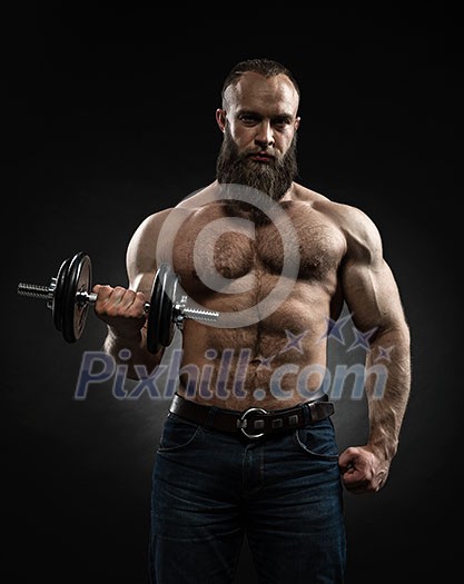 Strong bearded bodybuilder with six pack, perfect abs, shoulders, biceps, triceps and chest. Power athletic bearded man in training pumping up muscles with dumbbell. Strong bearded bodybuilder with six pack, perfect abs, shoulders, biceps, triceps and chest. Power athletic bearded man in training pumping up muscles with dumbbell.