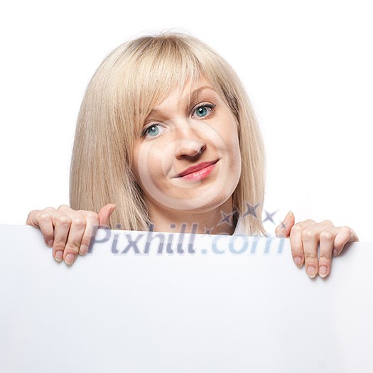 Smiling woman holding white empty paper Smiling woman holding white empty paper