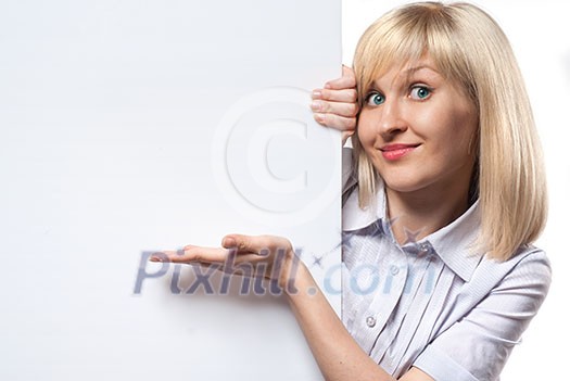 Attractive smiling woman holding white empty paper and pointing on it isolated on white Attractive smiling woman holding white empty paper and pointing on it isolated on white