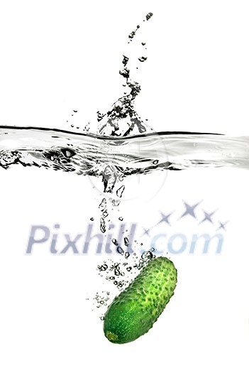 green cucumber dropped into water isolated on white green cucumber dropped into water isolated on white