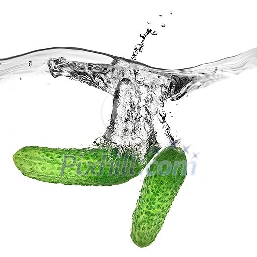 green cucumbers dropped into water isolated on white green cucumbers dropped into water isolated on white