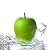 fresh water splash on green apple isolated on white