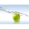 fresh water splash on green apple isolated on white