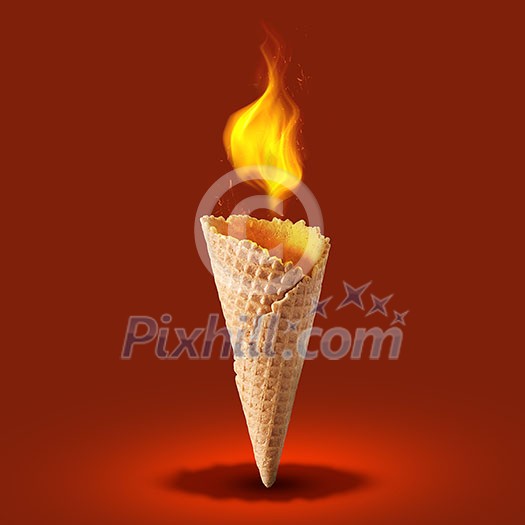 Sweet wafer cone with fire on red background. Side view. Sweet wafer cone with fire on red background. Side view.
