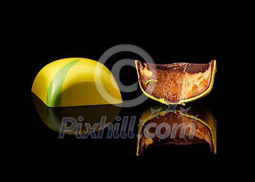 tasty yellow chocolate candy on a black background tasty yellow chocolate candy on a black background