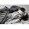 winter warm jacket and sweater on a gray background