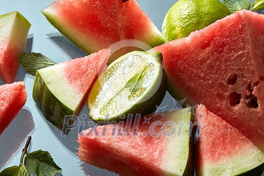 watermelon and lime slices on a plate watermelon and lime slices on a plate