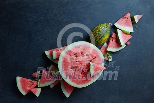pieces of fresh watermelon with melon on a black background pieces of fresh watermelon with melon on a black background