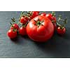 Cherry red tomatoes on Black Stone Surface