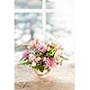 Bouquet of colorful flowers arranged in small vase