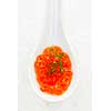 Closeup of caviar with dill garnish in white spoon on ice