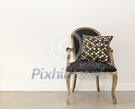 Antique armchair furniture with cushion against white wall Antique armchair furniture with cushion against white wall