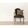 Antique armchair furniture with cushion against white wall