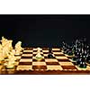 Close up of chess pieces on wooden chessboard