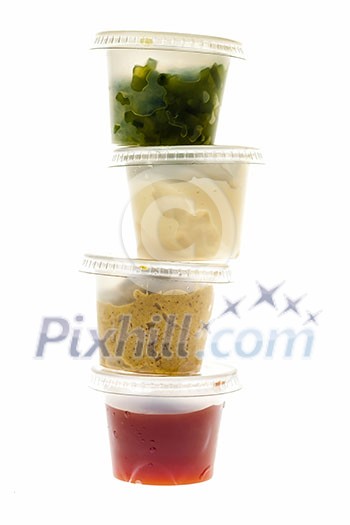 Relish mustard ketchup and mayonnaise condiments in clear containers stacked on white background Relish mustard ketchup and mayonnaise condiments in clear containers stacked on white background
