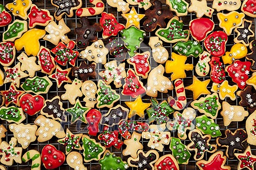 Cooling rack with freshly baked homemade shortbread Christmas cookies over wooden background from above Cooling rack with freshly baked homemade shortbread Christmas cookies over wooden background from above