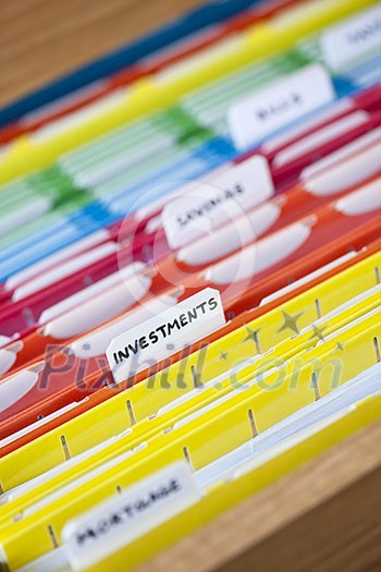 Open file folder drawer with many multicolored files containing personal finance documents Open file folder drawer with many multicolored files containing personal finance documents