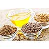 Bowls of whole and ground flax seed with linseed oil
