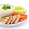 Healthy snack of hummus dip with pita bread slices and vegetables