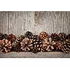 Rustic natural wooden background with pine cones