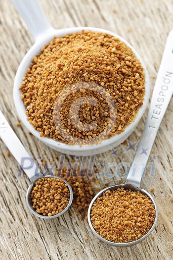 Organic coconut palm sugar in measuring spoons Organic coconut palm sugar in measuring spoons