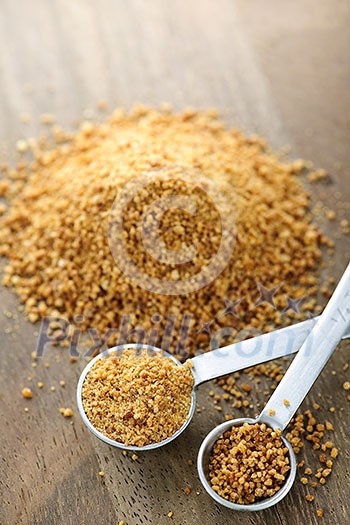 Organic coconut palm sugar in measuring spoons Organic coconut palm sugar in measuring spoons