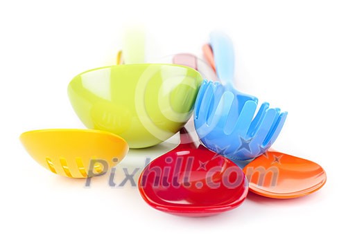 Various colorful plastic kitchen utensils on white background Various colorful plastic kitchen utensils on white background