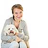 Pretty teenage girl holding adorable coton de tulear dog