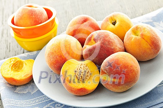 Ripe juicy peaches on a plate ready to eat Ripe juicy peaches on a plate ready to eat