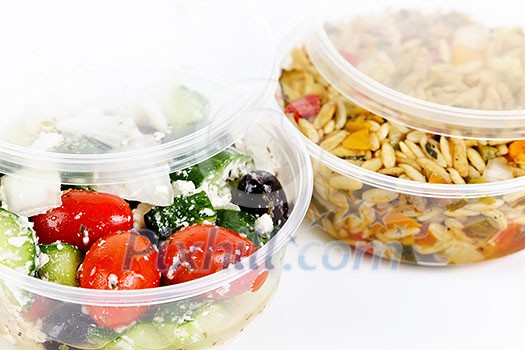 Two servings of prepared salad in plastic takeaway containers Two servings of prepared salad in plastic takeaway containers